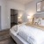 a bedroom with a bed and lamps