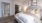 a bedroom with a bed and lamps