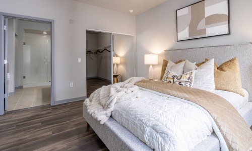 a bedroom with a bed and lamps