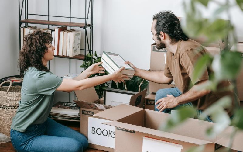 a man and a woman unpacking boxes